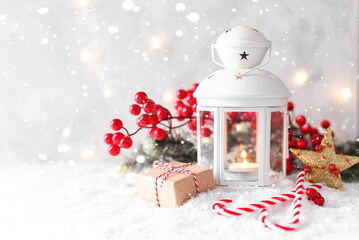 White lantern and red decorations on snow