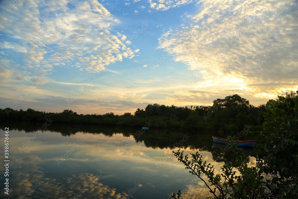 Wall mural Boat on the lake with beautiful clouds