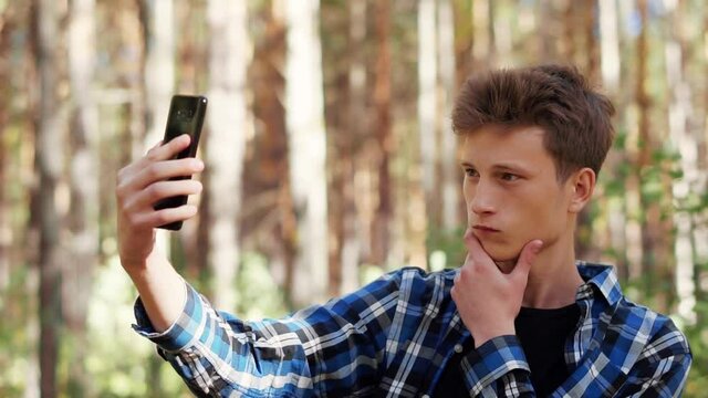 Young man makes a selfie on the phone