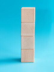 Wooden cube on blue background with space for text