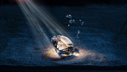 A diamond lying under water in a ray of light.