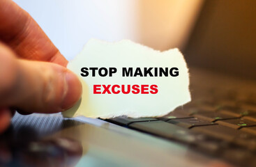 Motivational text Stop making excuses on paper on notebook background.