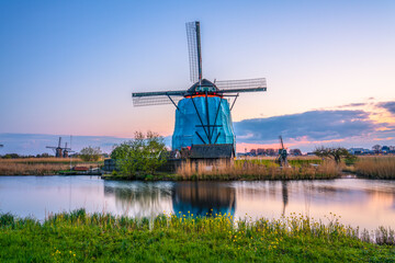 Fototapeta na wymiar Traditional Dutch windmill at sunset in Kinderdijk. Netherlands 