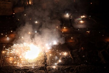 Bokeh shot of artificial fireworks during Diwali festival in India with selective focus. Candles and fire crackers are lighten up during Dev Diwali festival in Varanasi with copy space.