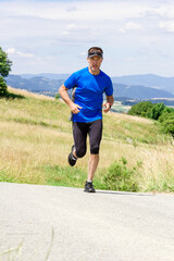 Runner athlete running on road at mountains background