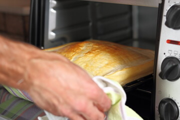 Removing baked puff pastry base from oven. Making Chicken and Egg Galette Series.
