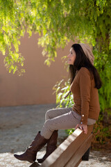 Naklejka premium A lady resting on a park bench