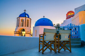 Beautiful sunset view of blue domes of Oia in Santorini island, Greece 