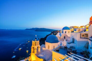 Beautiful sunset view of blue domes of Oia in Santorini island, Greece