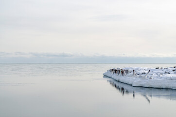 Horizon. Snow. Frosty winter morning by the sea. Sakhalin island. Marina Berth in the winter.