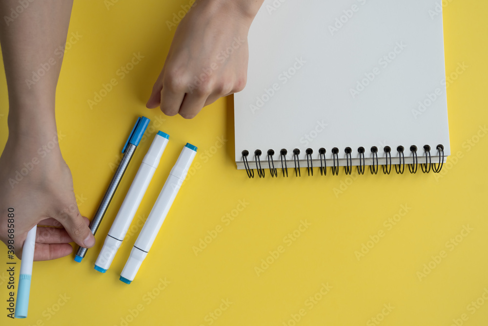 Poster top view of a desk with markers and a notepad