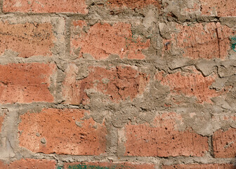 Red brick wall. Sloppy concrete seams.