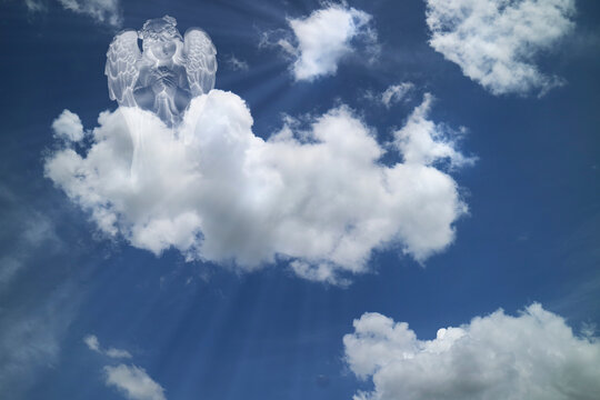 Little Angel in white clouds with light ray from  heaven. religion,