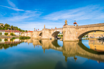 Beautiful view of old main bridge of Wurzburg with reflection in the river. Germany
