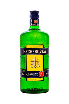 Minsk, Belarus - 04.01.2020: vertical photo of the original BECHEROVKA herbal liqueur bottle covered with drops of water isolated on white