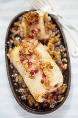 Halibut fish roulades with pomegranate and wallnuts