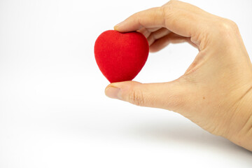 Red heart in a hand on white background