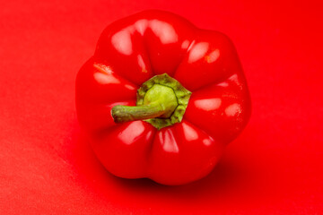 Luscious vibrant Bell pepper or fresh paprika with its folds and stem turned to the camera against...