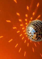 Mirror disco ball sun glare abstract orange background, banner, frame, postcard. Disco festive new year xmas winter theme.