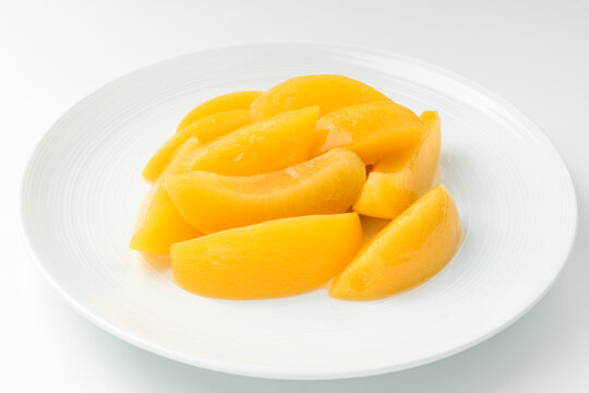 Canned peaches on a white background