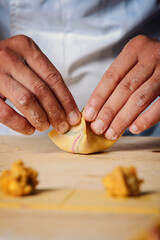Chef hands creating colorful ravioli..Italian concept food.