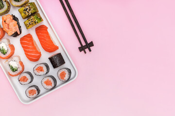 Sushi set with salmon on pink background