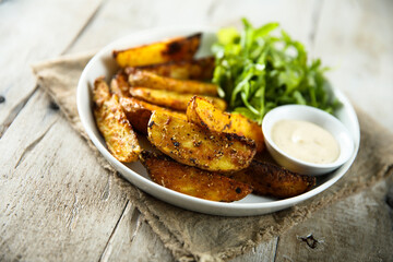 Roasted potato wedges with salad and dip