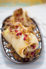Halibut fish roulades with pomegranate and wallnuts