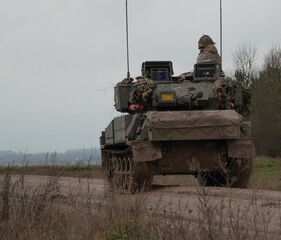 Fototapeta premium british army scimitar FV107 light tank reversing at high speed during a firepower demonstration on salisbury plain
