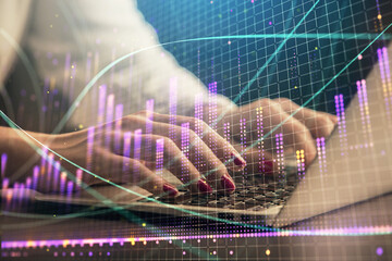 Double exposure of businesswoman hands typing on computer and forex chart hologram drawing. Financial analysis concept.