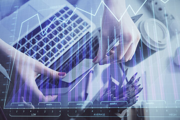 Double exposure of businesswoman hands typing on computer and financial graph hologram drawing. Stock market analysis concept.