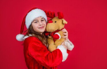 happy new year teen girl wear red santa claus hat and costume hold reindeer toy, best present