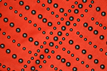 suede bright orange trendy color texture or background with metallic decor or decoration, womens clothing pattern close-up