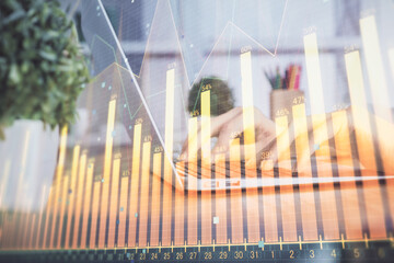 Double exposure of woman hands typing on computer and forex chart hologram drawing. Stock market invest concept.