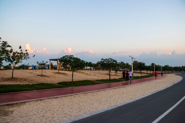Jogging and cycling trucks in the park at early morning hour. Outdoors