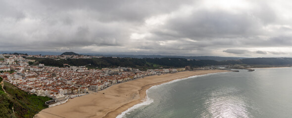view of the beach and town of Nazare on the coast of Portugal