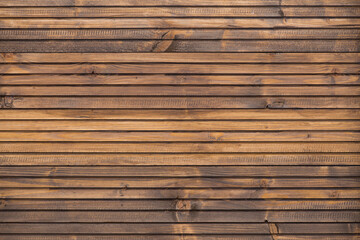 Fine wood background in dark brown tone. in horizontal position. texture and detail of wood fence. A fine detail background for abstract design. Wooden brown background. Smooth and polished wood
