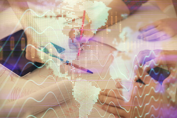Double exposure of forex graph drawing and man and woman working together holding and using a mobile device. Trade concept.