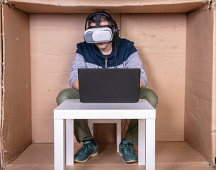 employee with virtual reality glasses working in his home cardboard office