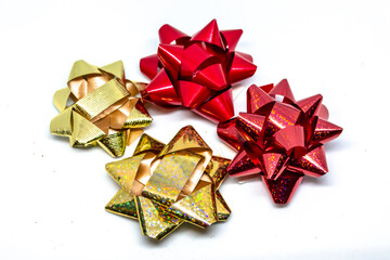 Red and gold gift bows on a white background