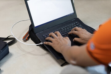 Onsite service technician use computer notebook to checking internet system.