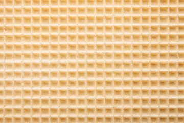 Empty wafer texture as background. Closeup view of golden waffle. Top view