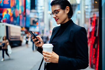 Female entrepreneur using cellphone on street