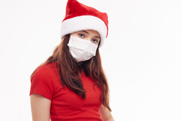 Fototapeta na wymiar girl in red t-shirt christmas hat medical mask protection close-up 