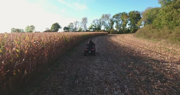Quad Bike Driving Slow on a Field on a Sunny Autumn Afternoon in South Sweden Sk&aring;ne &Ouml;sterlen, Aerial Low Altitude Following