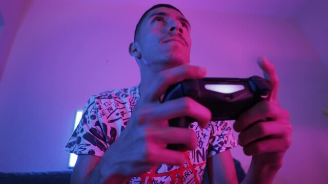 Young man playing with gaming controller