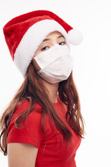 Fototapeta na wymiar girl wearing a medical mask santa hat holiday fun attractive look 