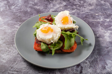 Poached eggs on vegetables. A sandwich with vegetables and poached eggs.