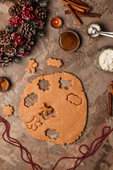 Cooking new year's ginger cookies. Christmas tree on the table with candles.