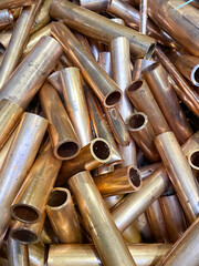 Thick walled new copper tube scrap, portrait view 